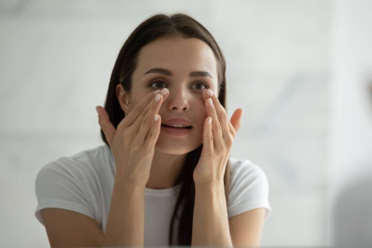 Young Woman Touching Under Eyes